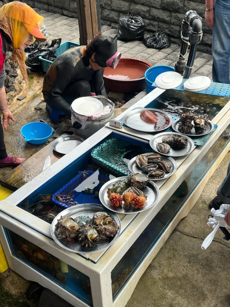 Fresh seafood sold by Jeju haenyeo after a dive