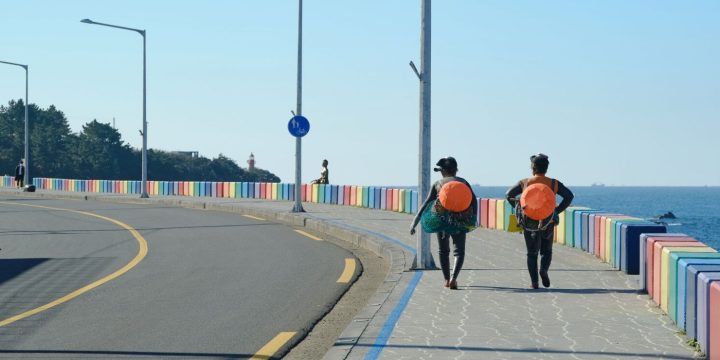 Haenyeo walking on Rainbow Coastal Road