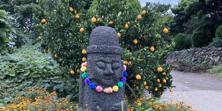 Hareubang with wild flowers and tangerines